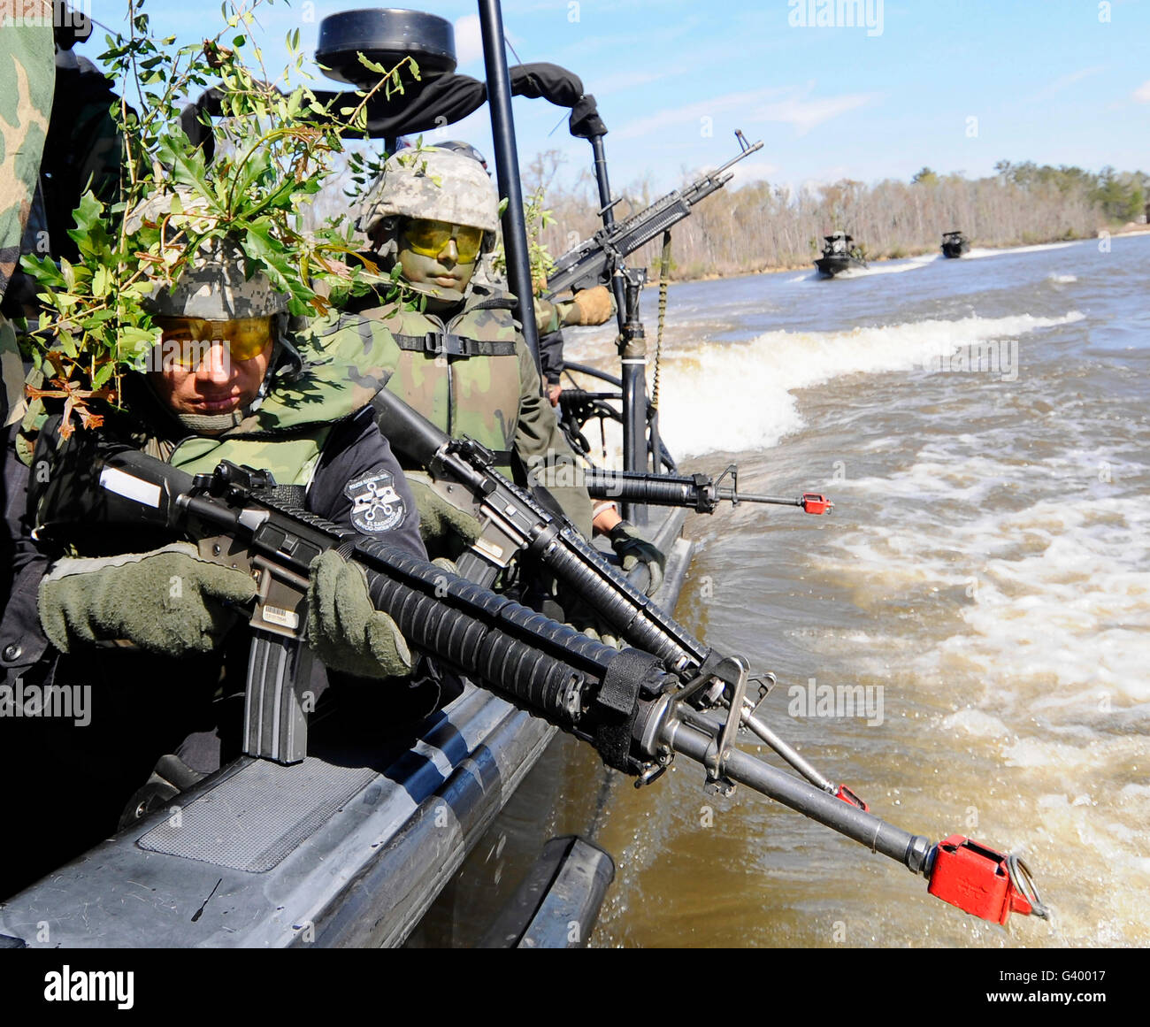Soldiers in camouflage at the Naval Small Craft Instruction doing a field training exercise. Stock Photo