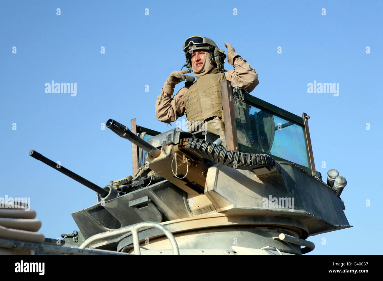 A U.S. Marine scanning the surrounding area from the turret of an amphibious assault vehicle in Saqlawiyah, Iraq. Stock Photo