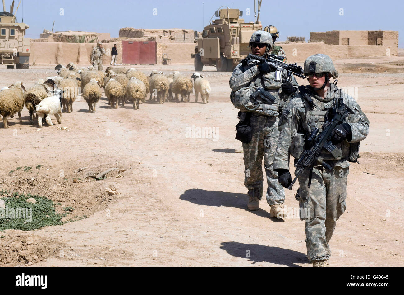 U.S. Army soldiers providing security while fellow soldiers provide humanitarian aid to villagers in Shuzayf, Iraq. Stock Photo