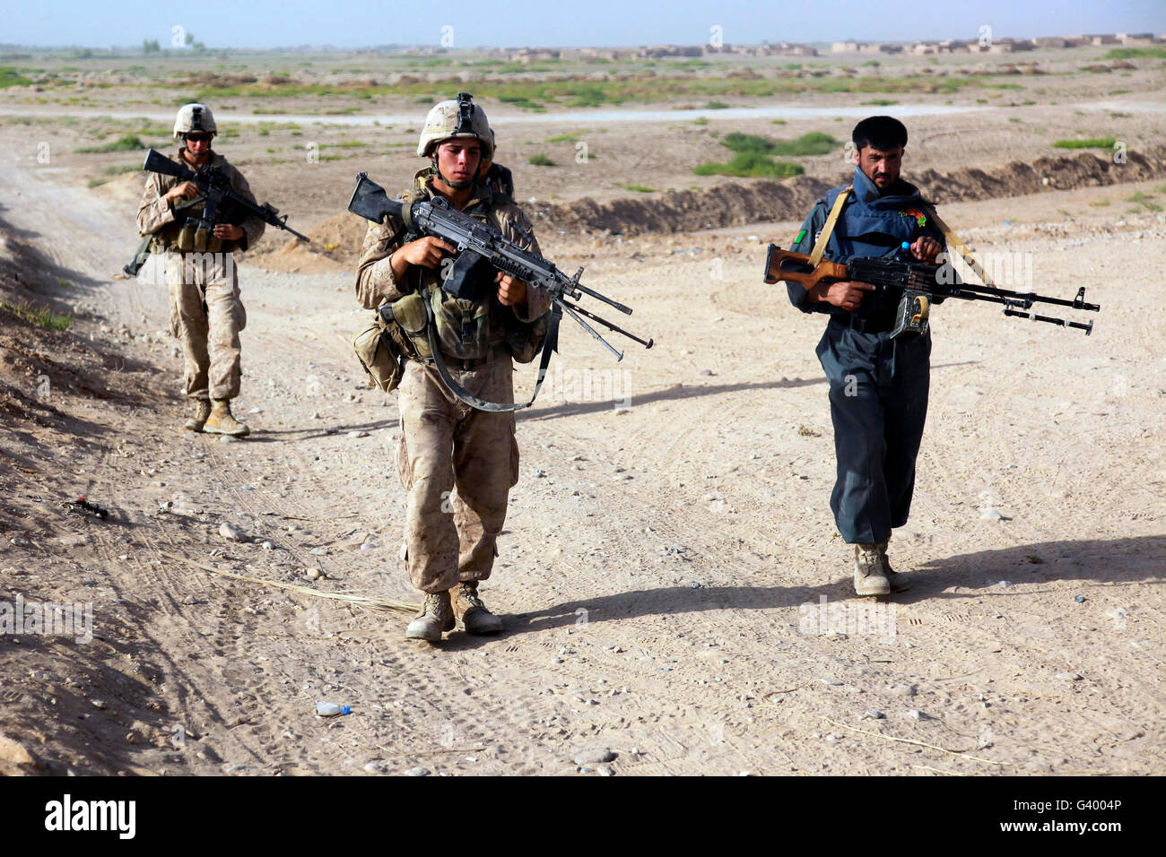 U.S. Marines and Afghan National Police officers conducting a security patrol in Afghanistan. Stock Photo