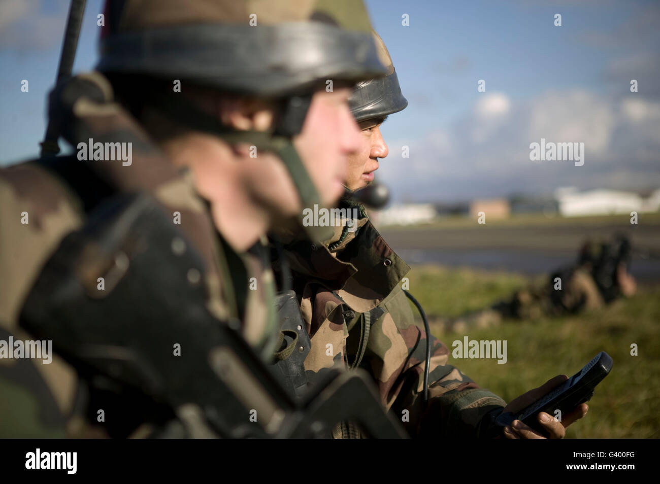 Members of the French Foreign Legion take orders over the radio after jumping over the airport of Tarbes, France, 2007 Stock Photo
