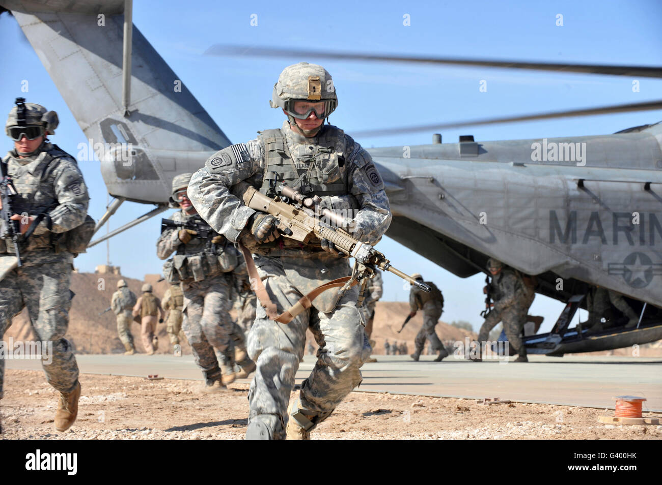 Running Soldier Loading A U.S. Army soldier runs over to provide security after unloading from ...