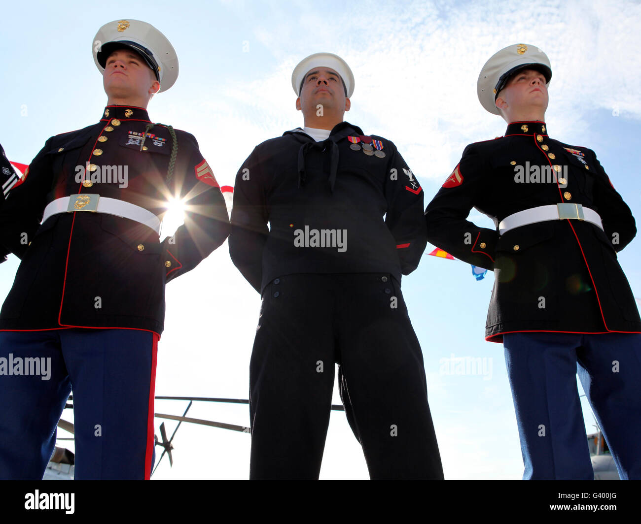 Marines and sailors man the rails aboard USS New York during the ship's commissioning. Stock Photo