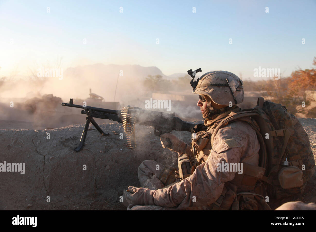 A U.S. Marine provides support by fire during Operation Cobra's Anger in Afghanistan. Stock Photo
