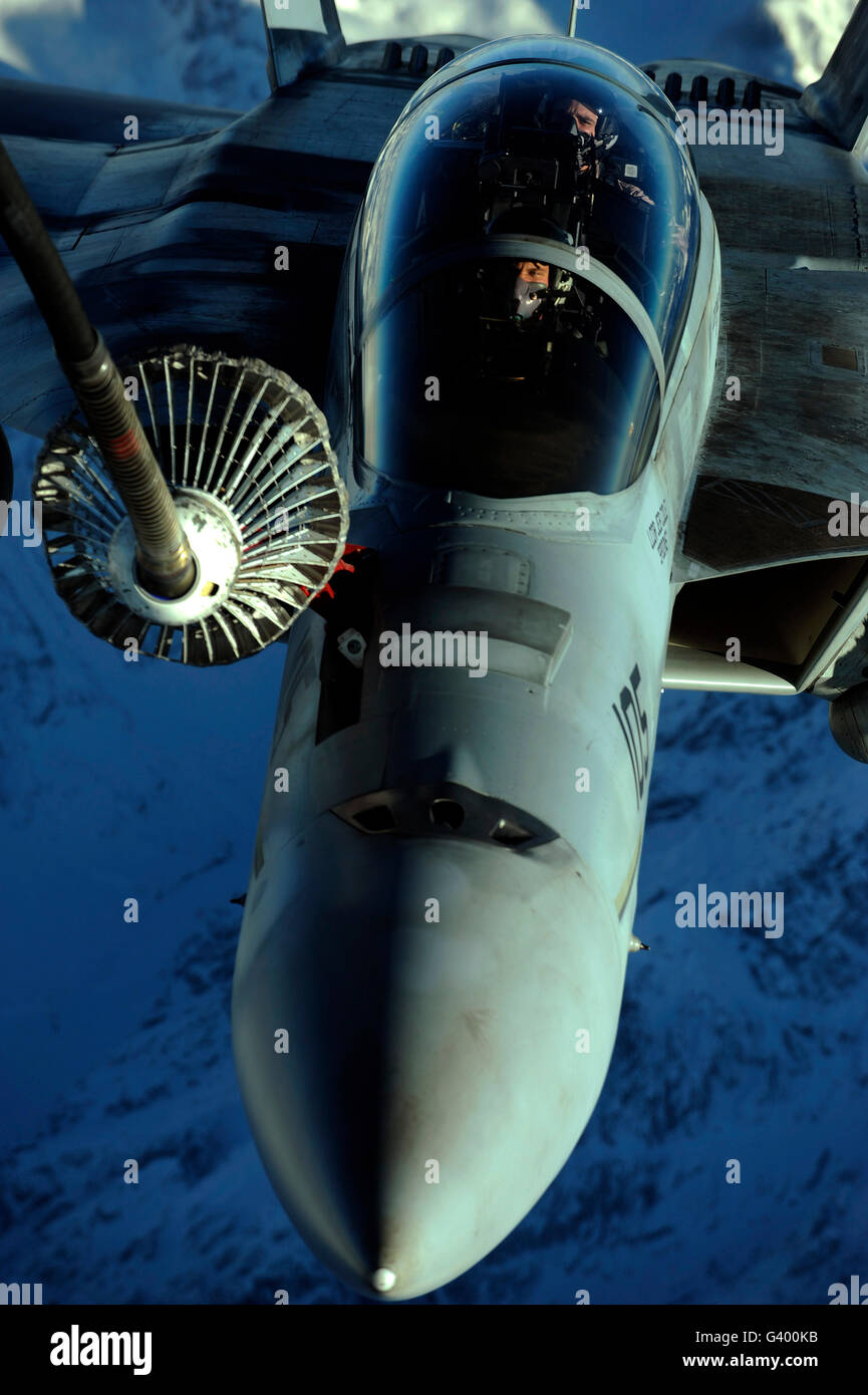 A U.S. Navy F-18 Hornet is refueled by a KC-10A Extender over Afghanistan. Stock Photo