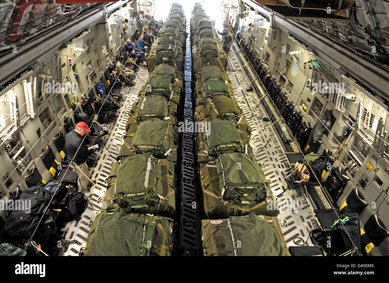 A C-17 Globemaster III cargo aircraft is loaded with 40 pallets of relief supplies. Stock Photo