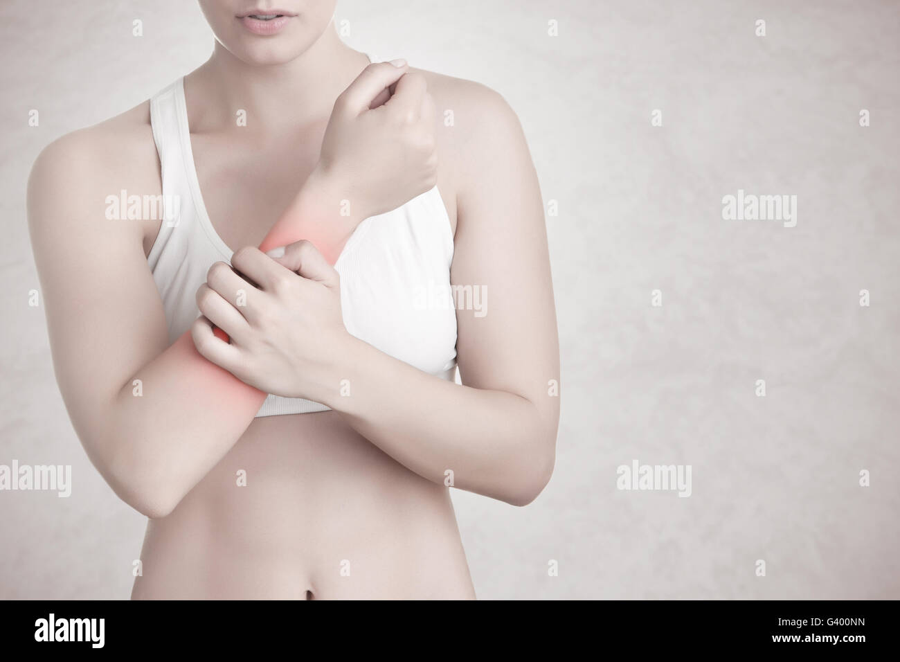 Female with pain in her forearm, isolated in a grey background Stock