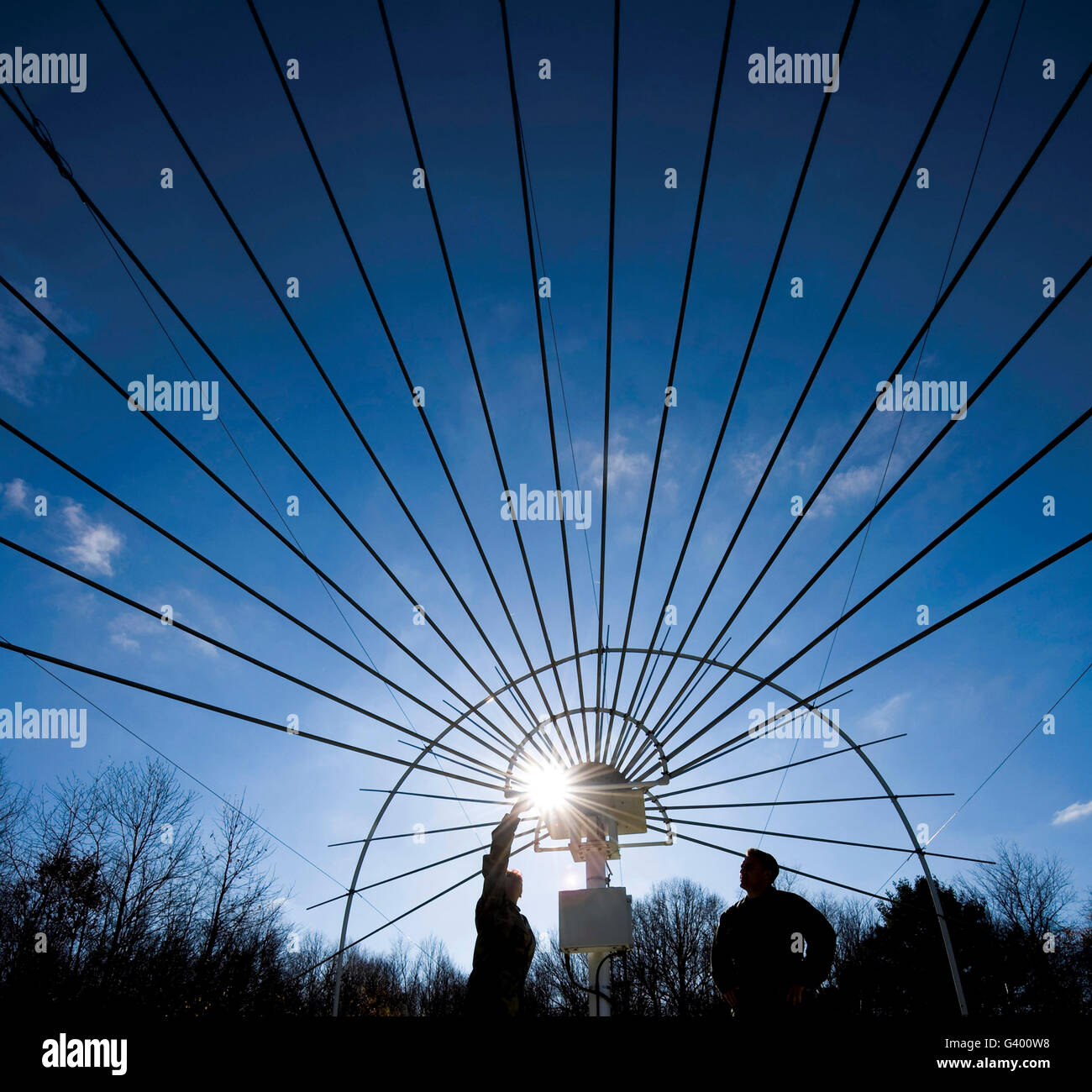 Electronic systems maintainers stand under a Solar Radio Spectrograph. Stock Photo