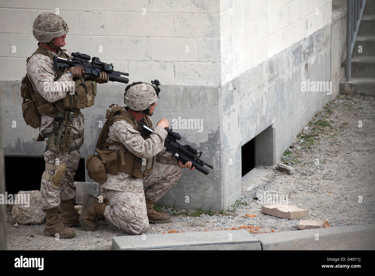 Marines practice patrolling streets in an urban environment. Stock Photo