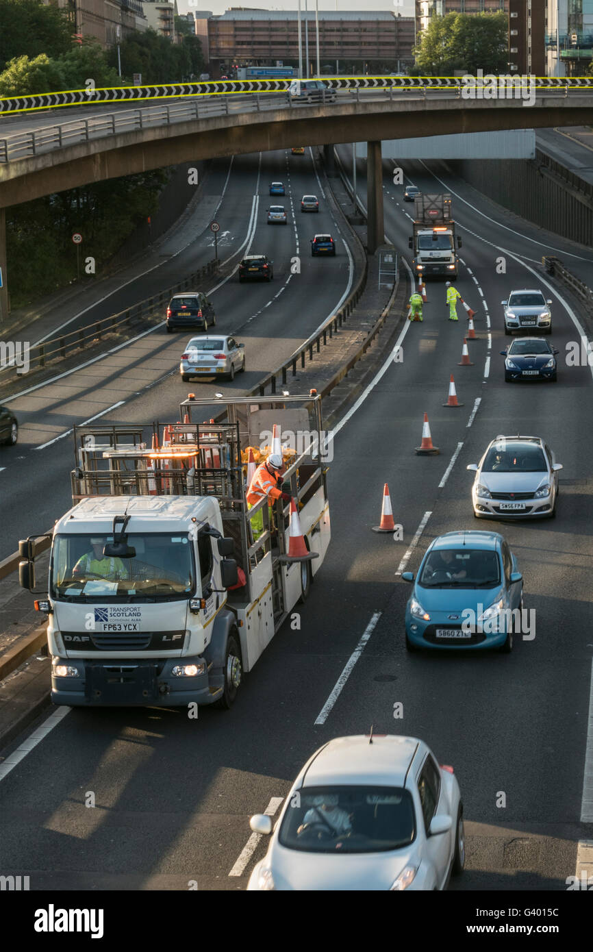 Workers putting out traffic cones on urban motorway,Glasgow,Scotland,UK, Stock Photo