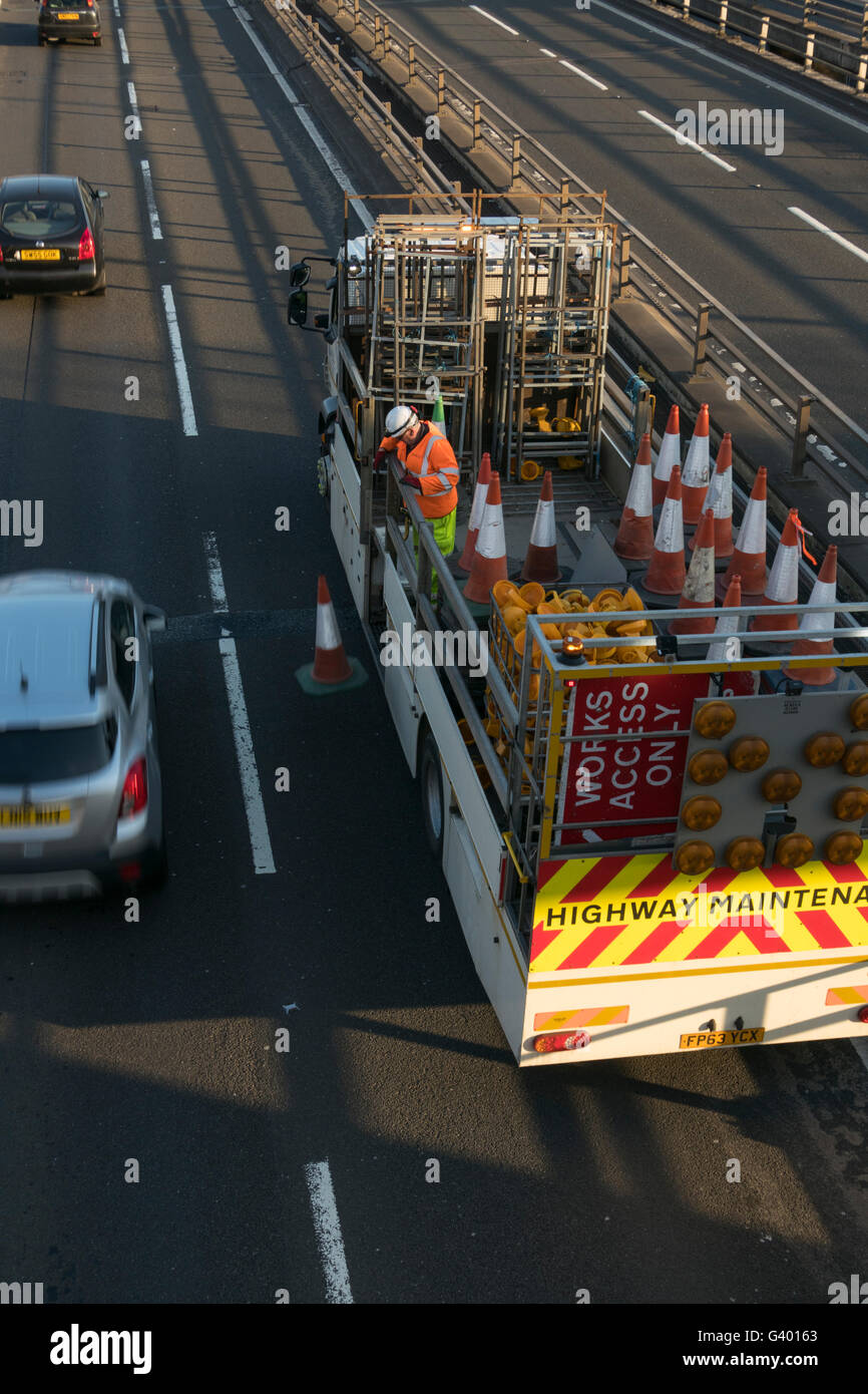 Worker putting out traffic cones on urban motorway,Glasgow,Scotland,UK, Stock Photo