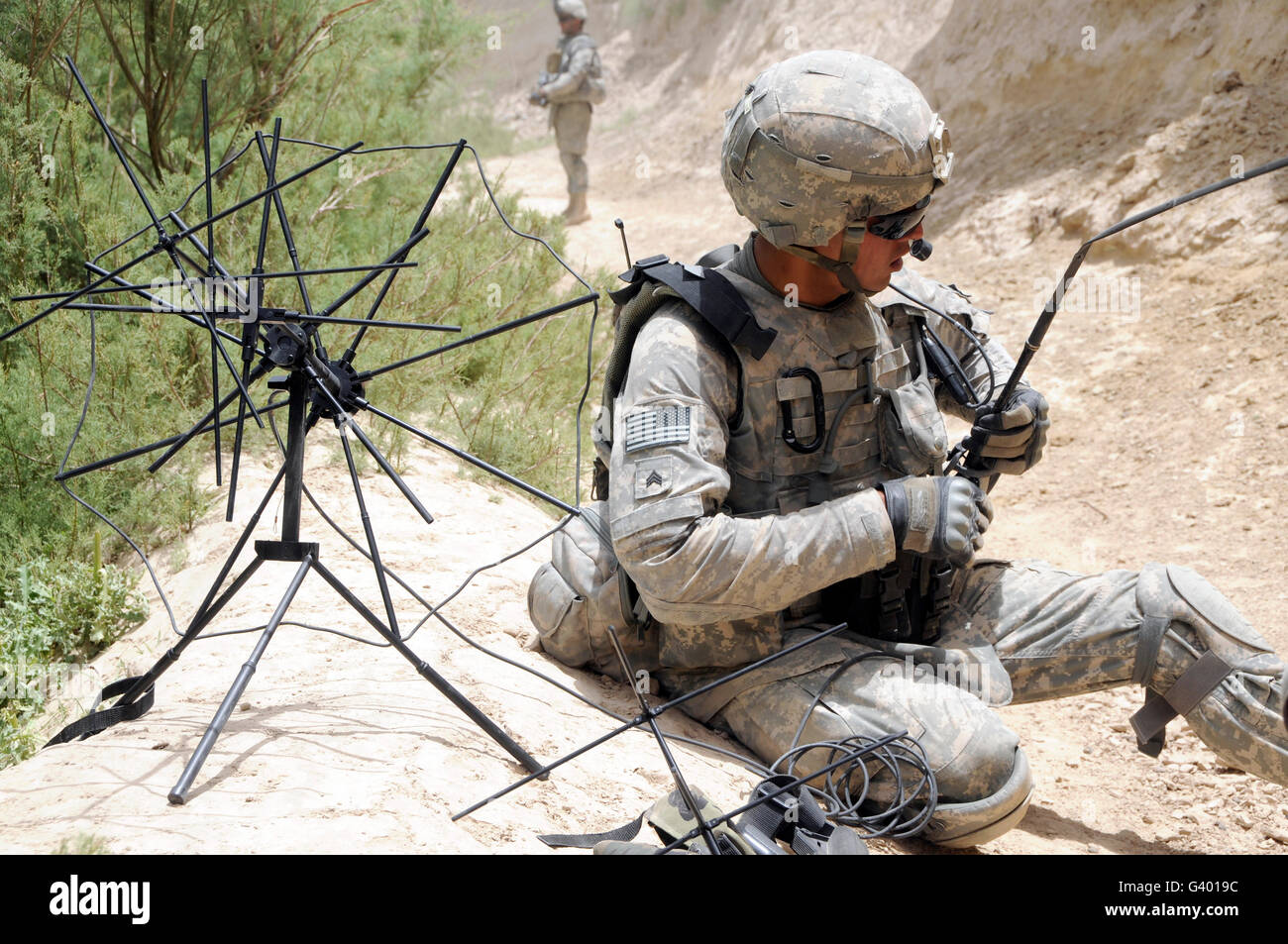 U.S. Army soldier sets up a tactical satellite system in the Zabul province of Afghanistan. Stock Photo