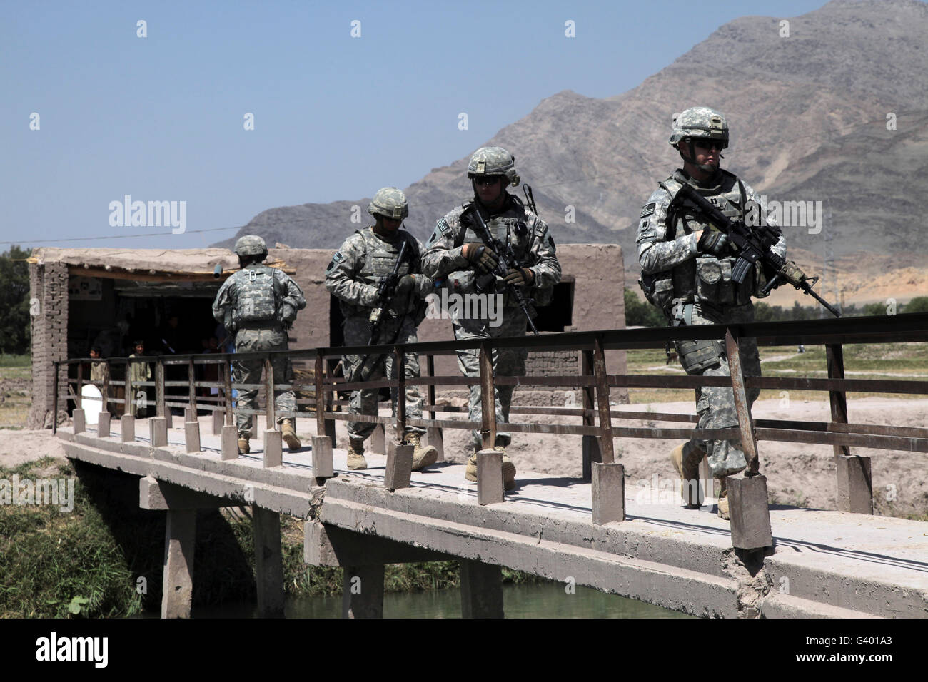 Members of the Provincial Reconstruction Team walk through a construction site in Afghanistan. Stock Photo