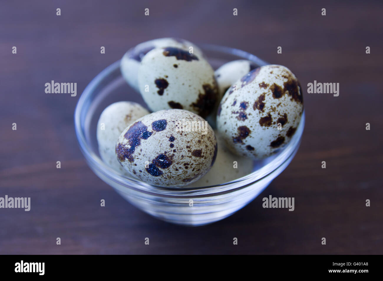 Bowl with quail eggs on a wooden table Stock Photo
