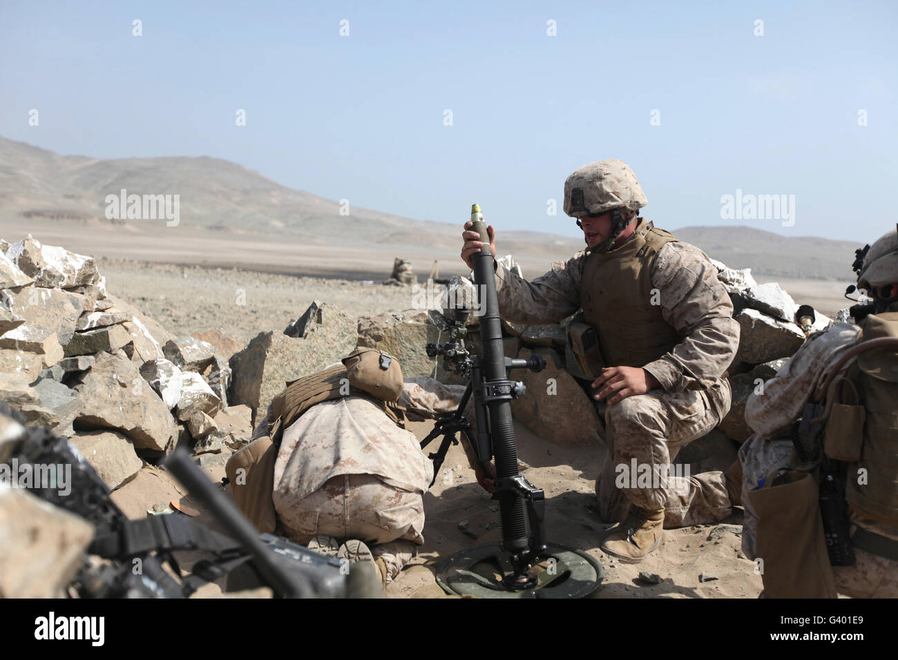 A U.S. Marine loads a mortar into a mortar tube Stock Photo Alamy