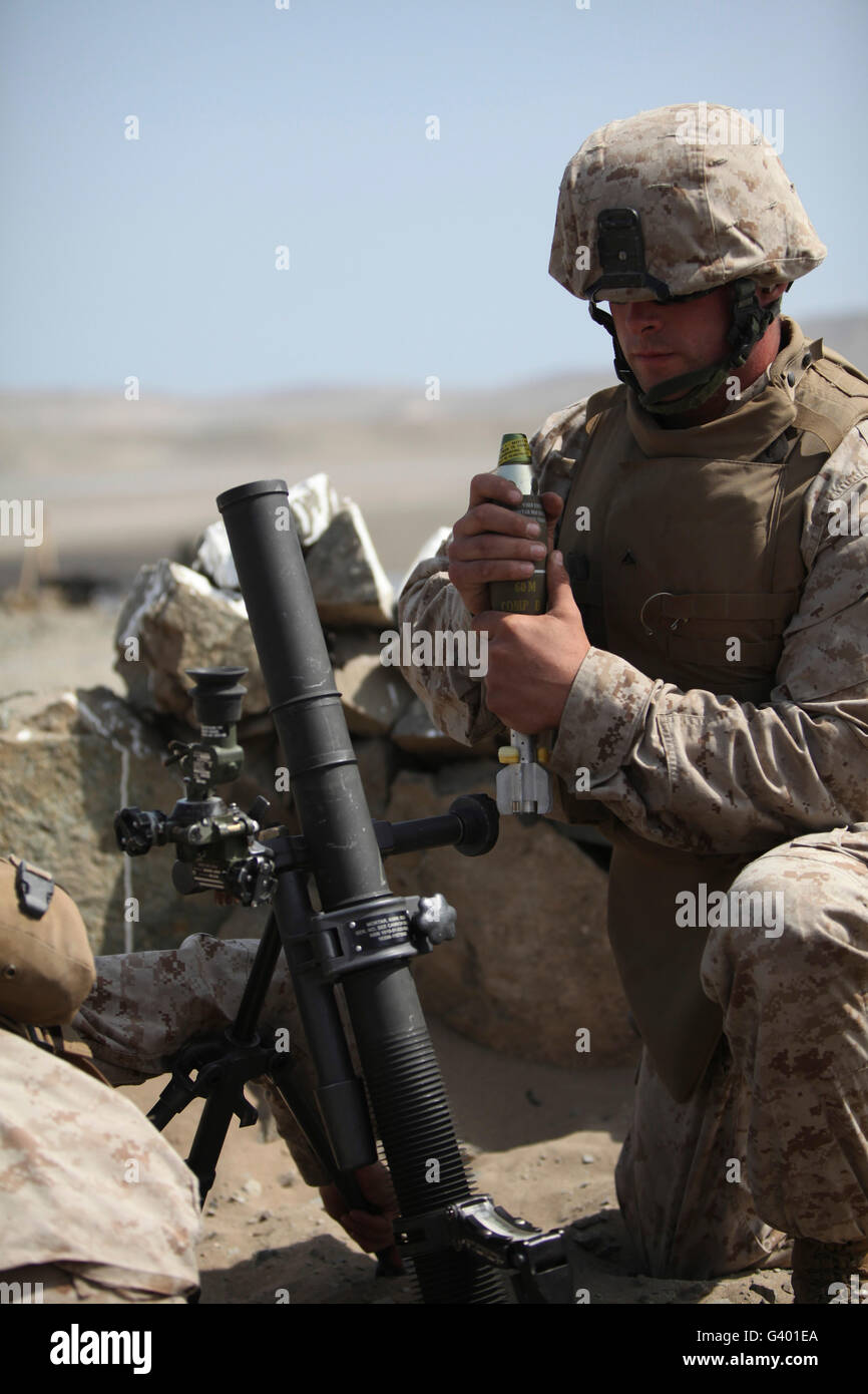 A U.S. Marine loads a mortar into a mortar tube Stock Photo Alamy