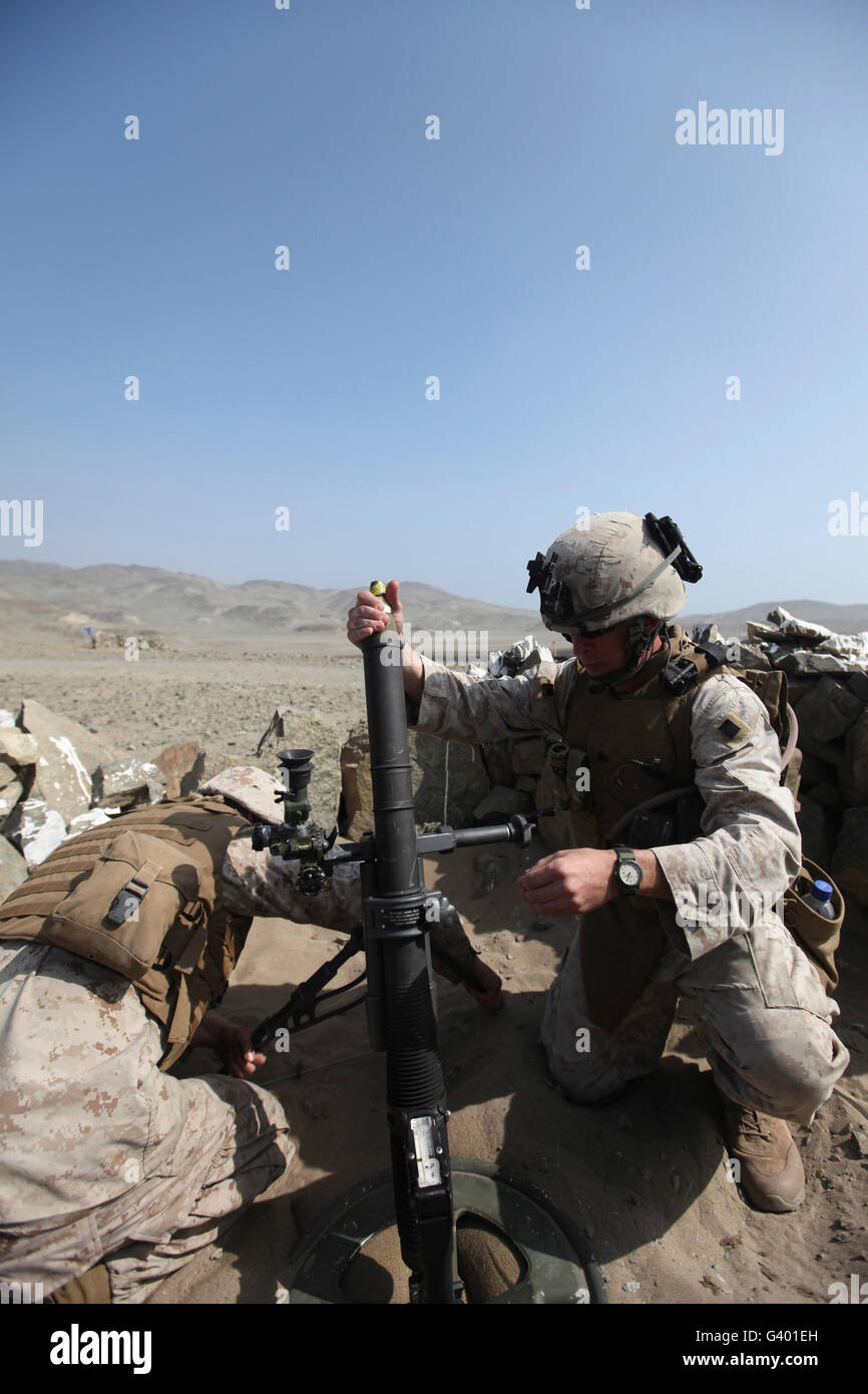 A U.S. Marine loads a mortar into a mortar tube Stock Photo Alamy