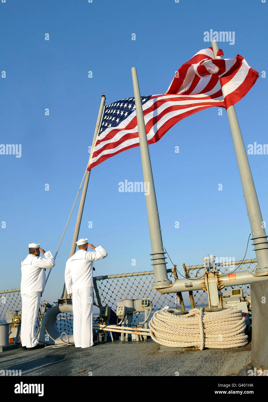 Sailors conduct morning colors aboard  USS Cole. Stock Photo