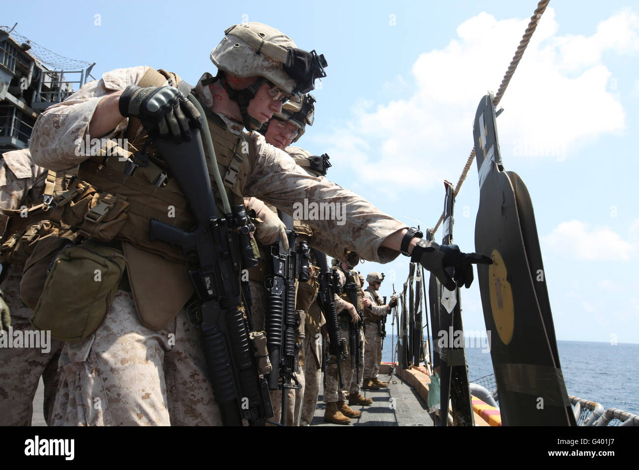 U.S. Marine looks over his target during a combat marksmanship program. - Stock Image