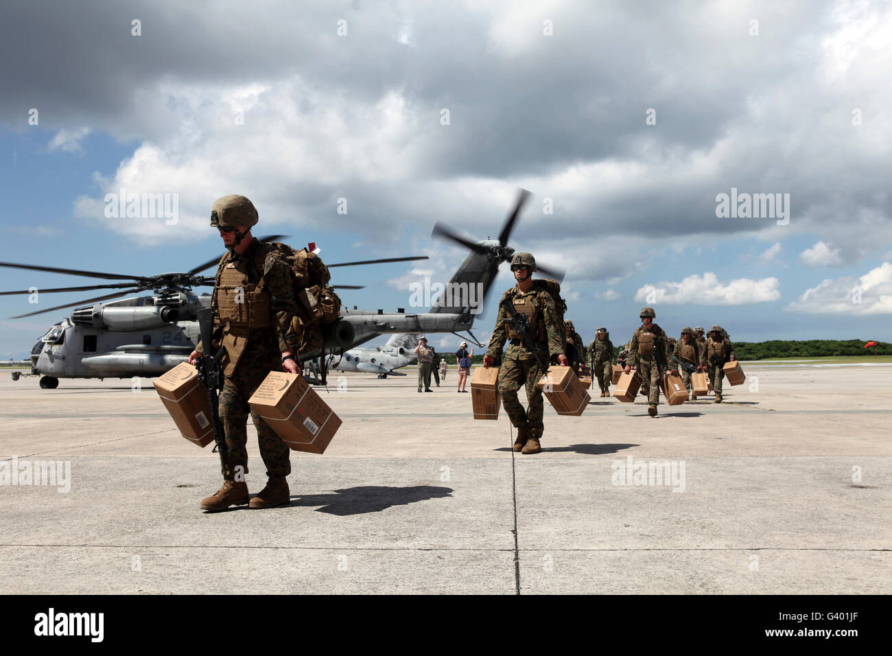 Marines carry supplies to a hangar. Stock Photo