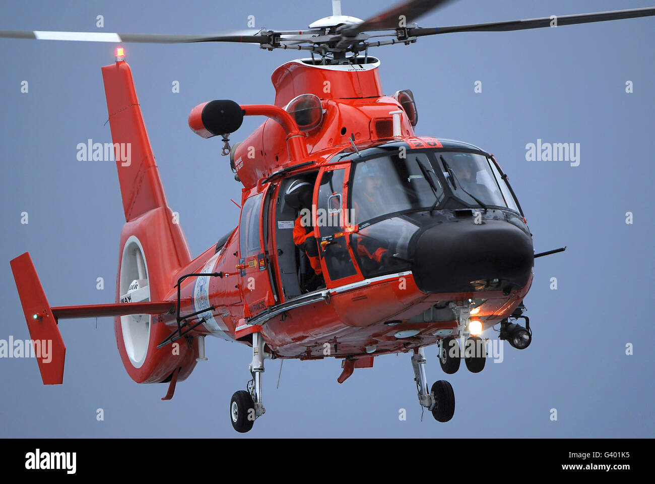 A Coast Guard MH-65 Dolphin helicopter  in flight. Stock Photo