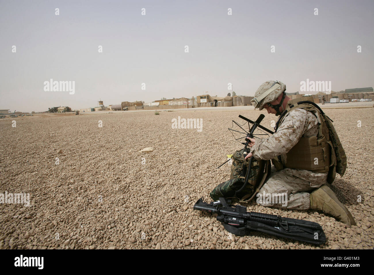 A field radio operator sets up satellite communication. Stock Photo