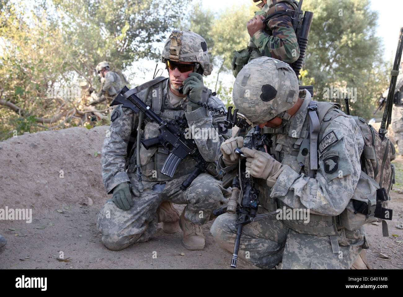 U.S. Army soldier radios in his team's status. Stock Photo
