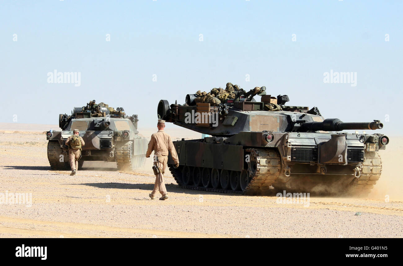 Marines guide two M1-A1 Abrams Main Battle Tanks. Stock Photo