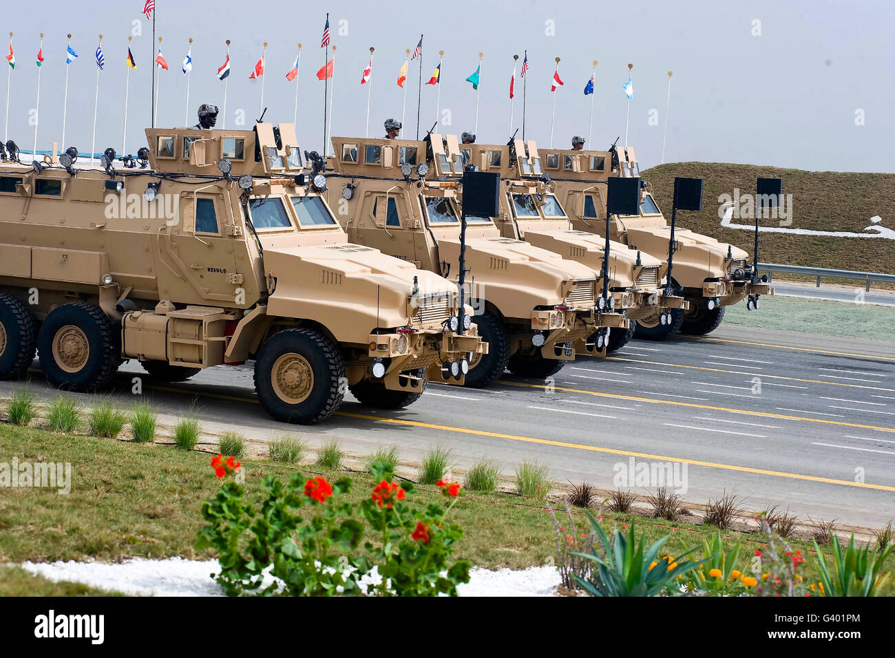 U.S. Army Caiman vehicles take part in the 50/20 Celebration parade in Kuwait. Stock Photo