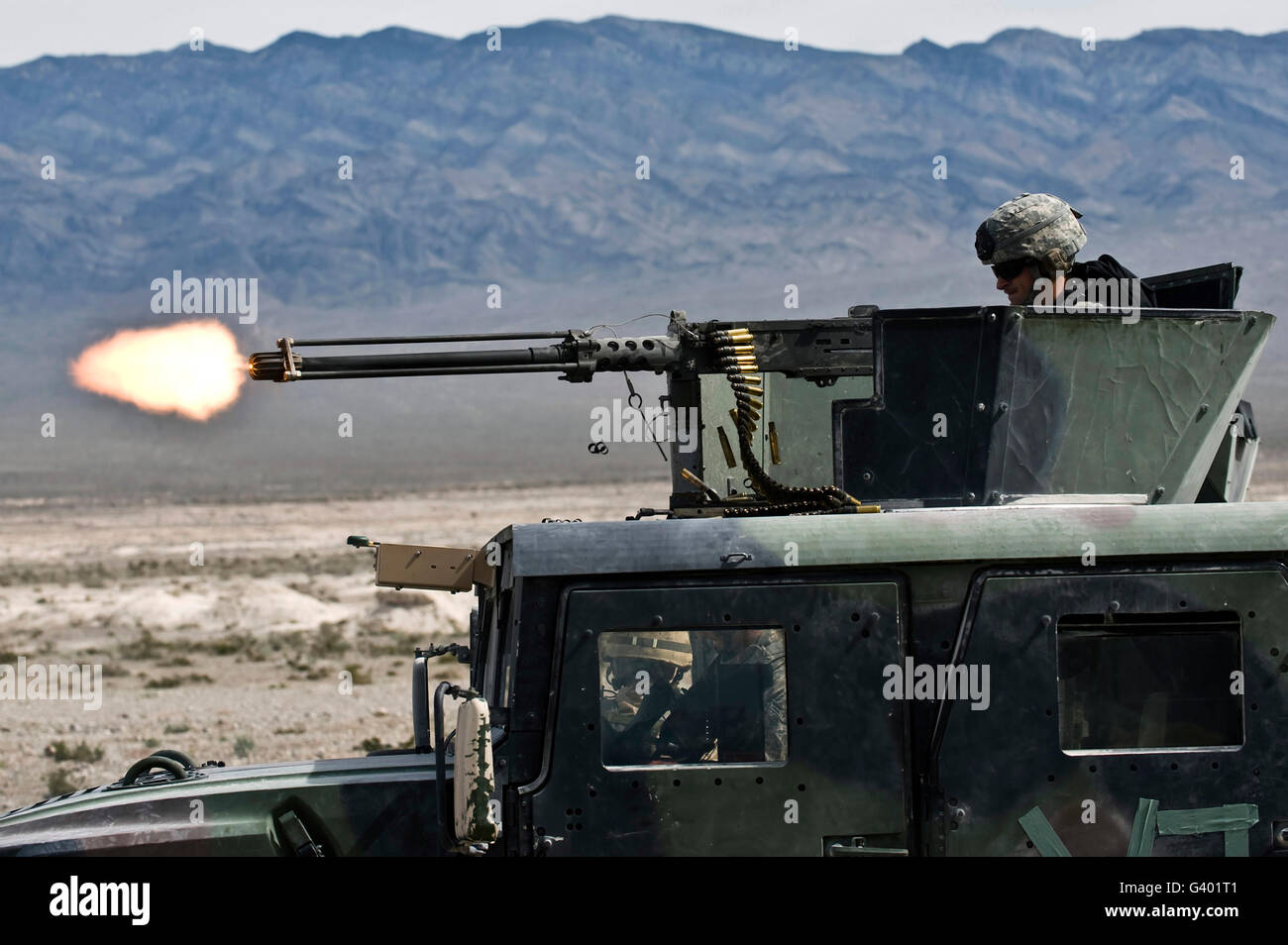 Airman fires a .50 caliber heavy machine gun. Stock Photo