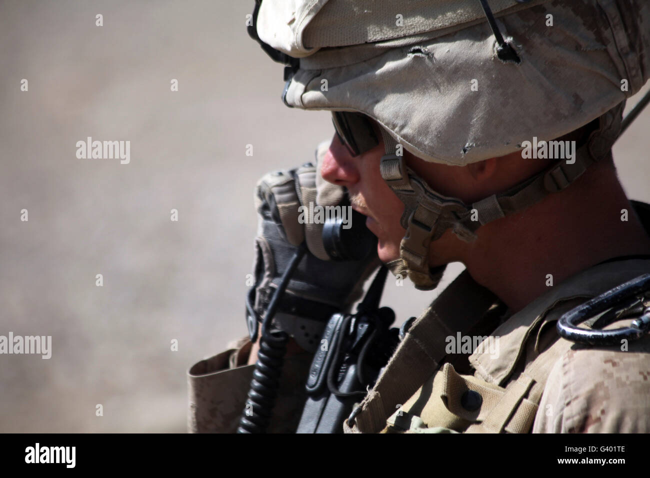 A squad leader puts his Marines into position over the radio. Stock Photo