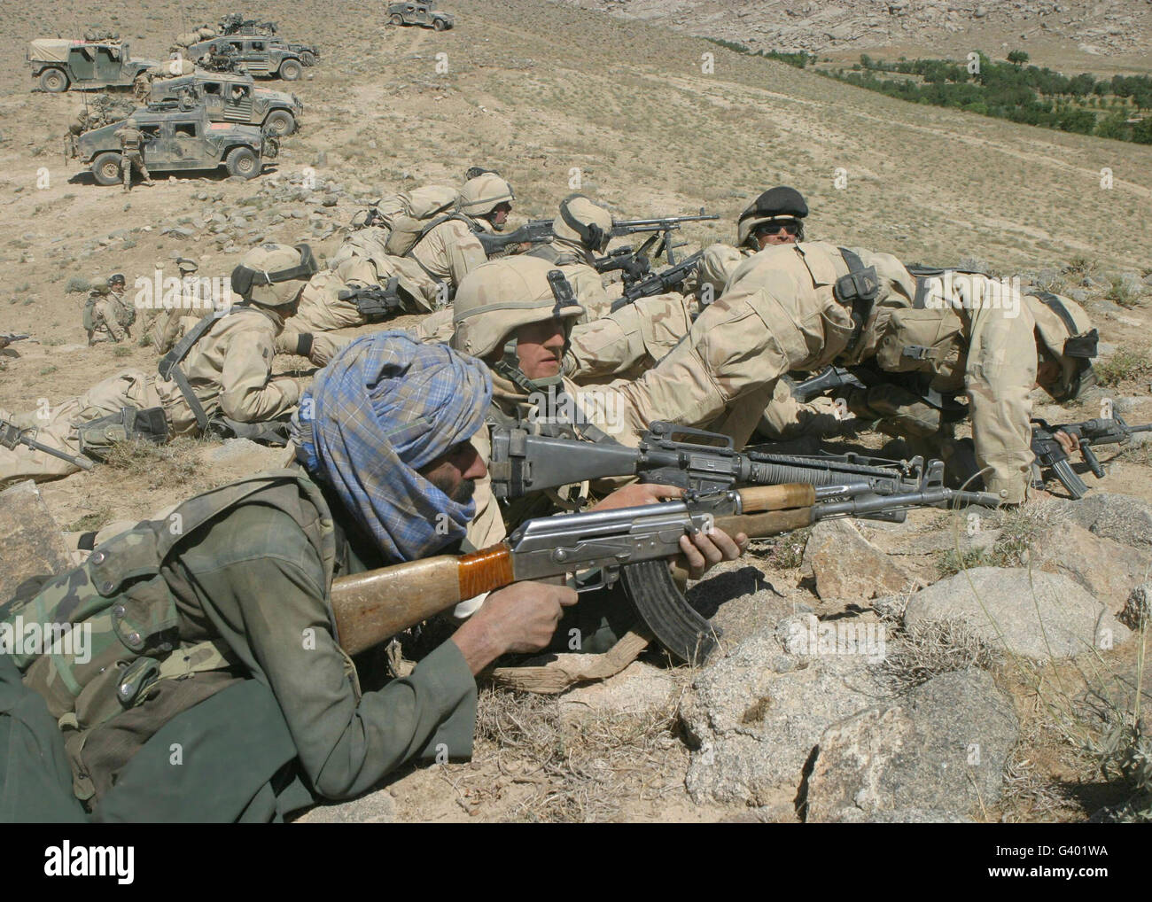 Marines form a skirmish line while under intense enemy fire in Afghanistan. Stock Photo