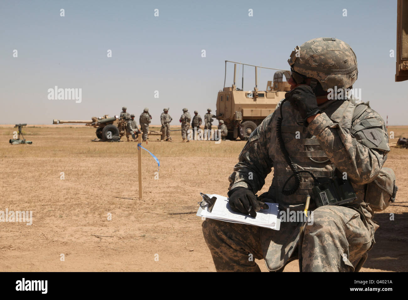 U.S. Army radio operator communicates during live fire qualifications. Stock Photo