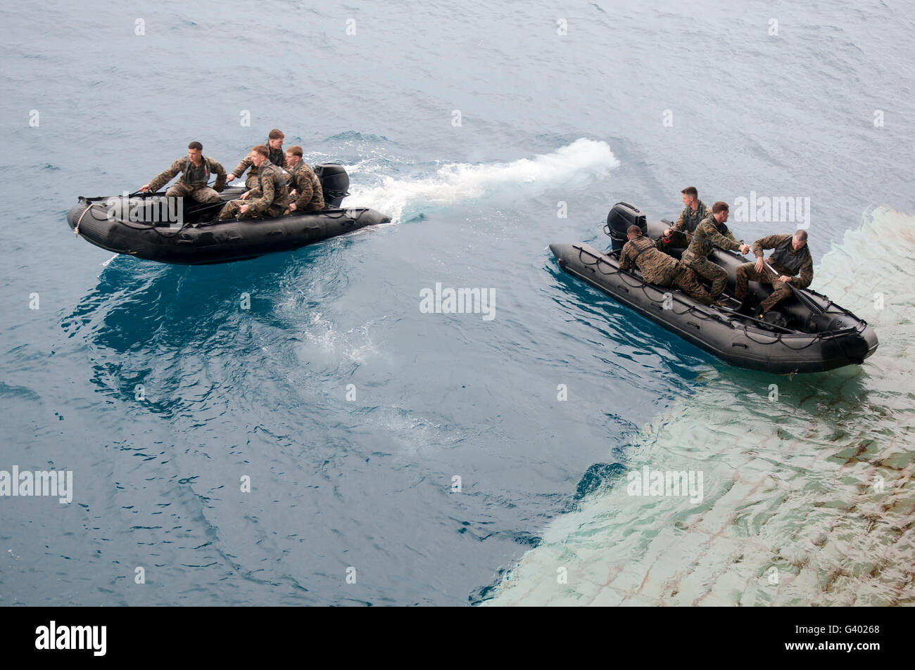 Marines depart the well deck of the amphibious assault ship USS Essex. Stock Photo