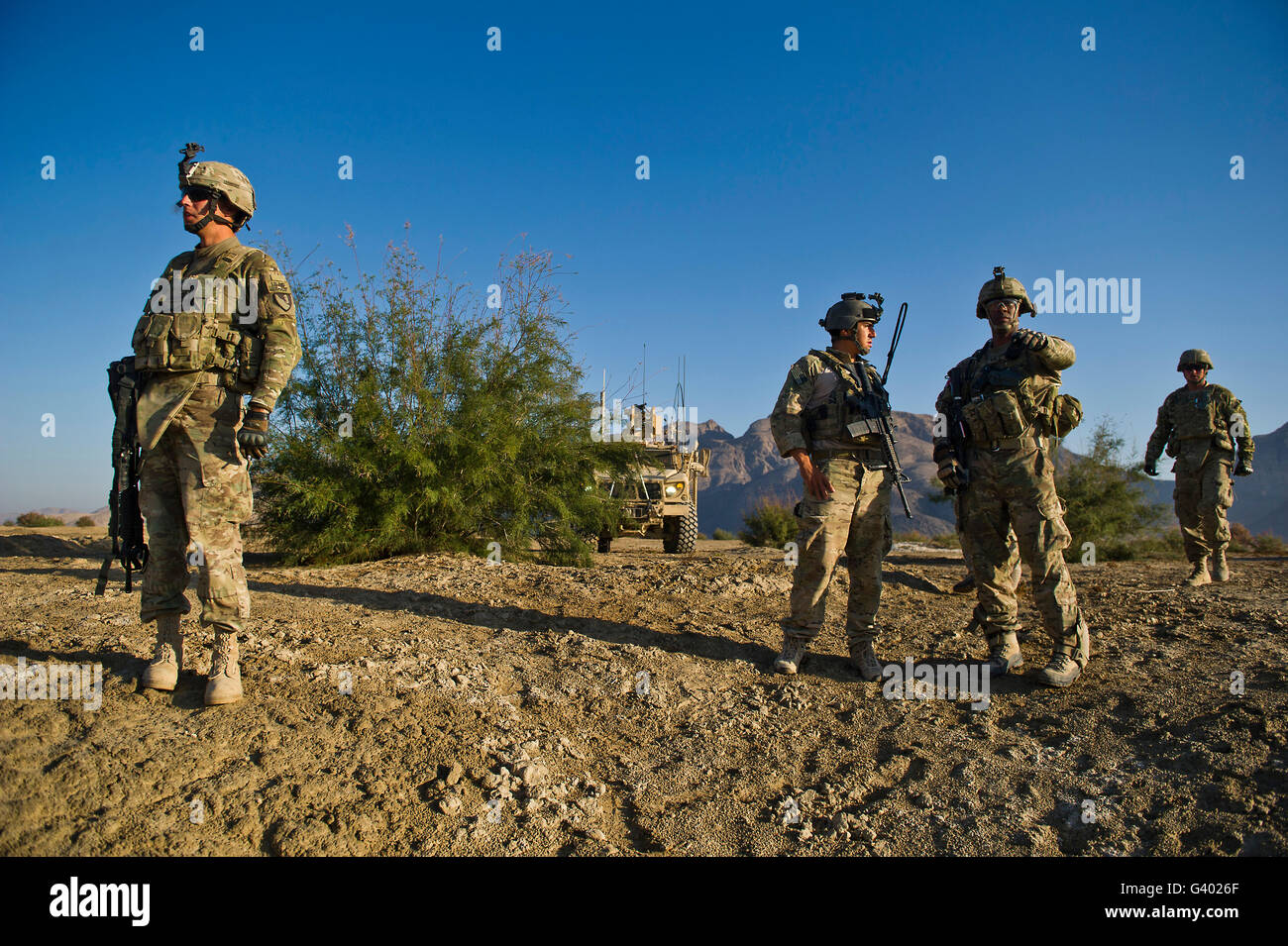 Soldiers discuss a strategic plan during an operation in Afghanistan. Stock Photo
