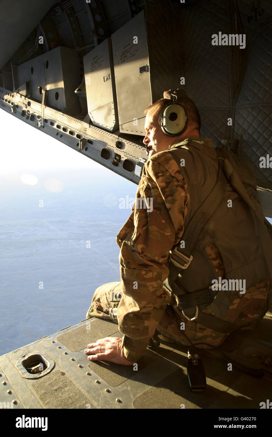 U.S. Air Force Commander sits harnessed on the back ramp of an Afghan Air Force C-27 Spartan. Stock Photo