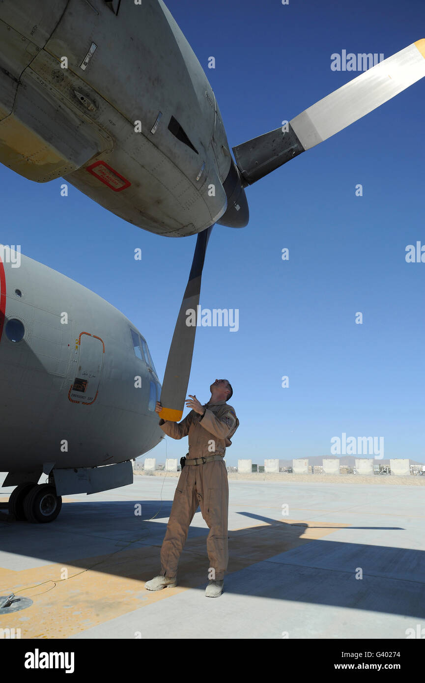 A flight engineer performs a pre-flight inspection of the rotor of an Afghan Air Force C-27 Spartan. Stock Photo