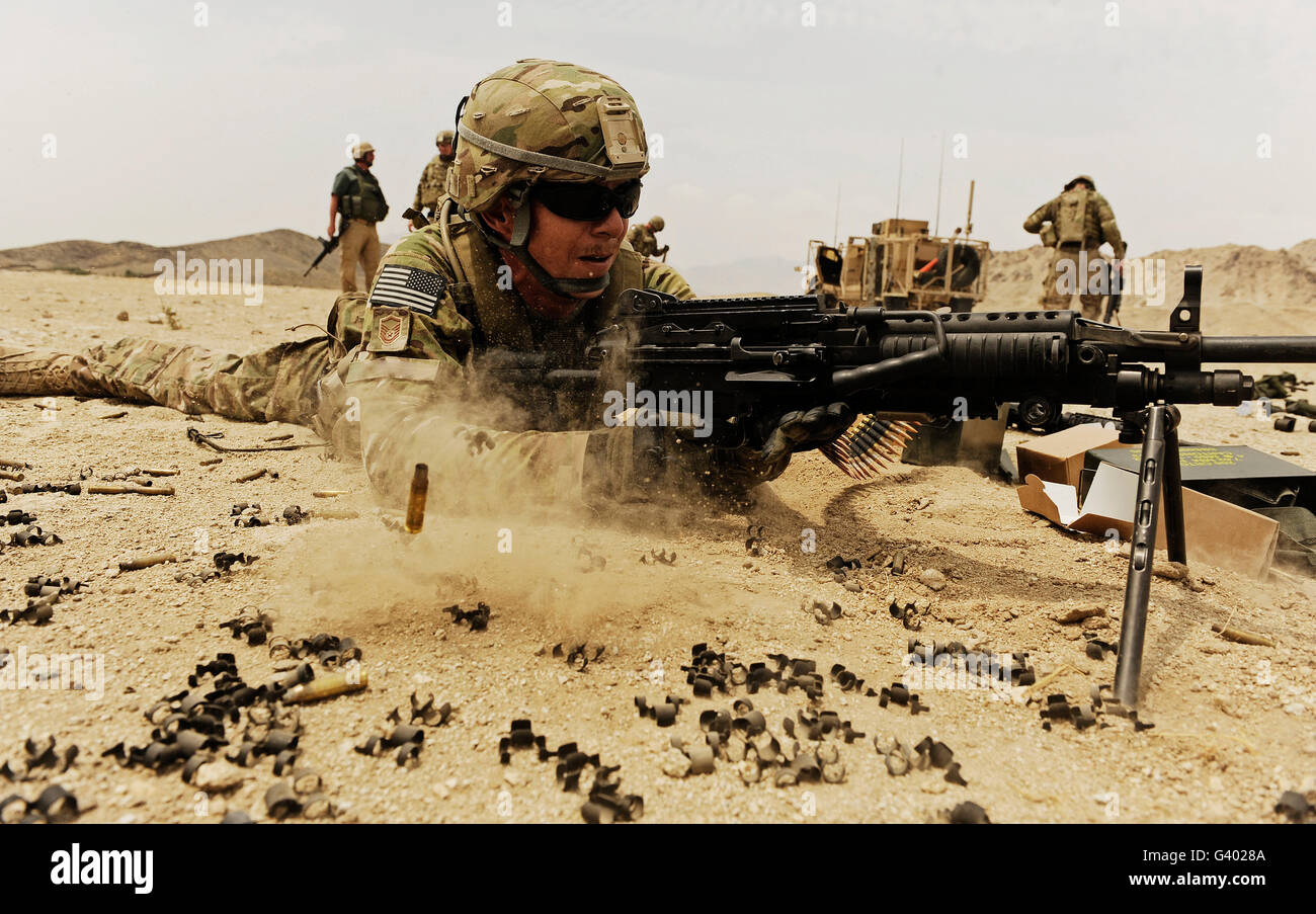 A soldier firing his Mk-48 machine gun. Stock Photo