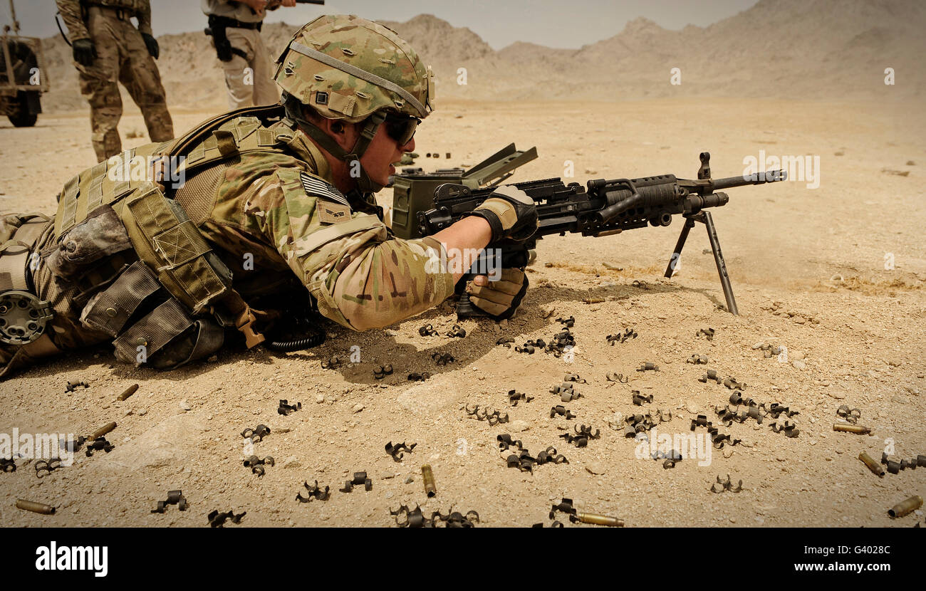 A soldier clears the Mk-48 machine gun on the firing range. Stock Photo