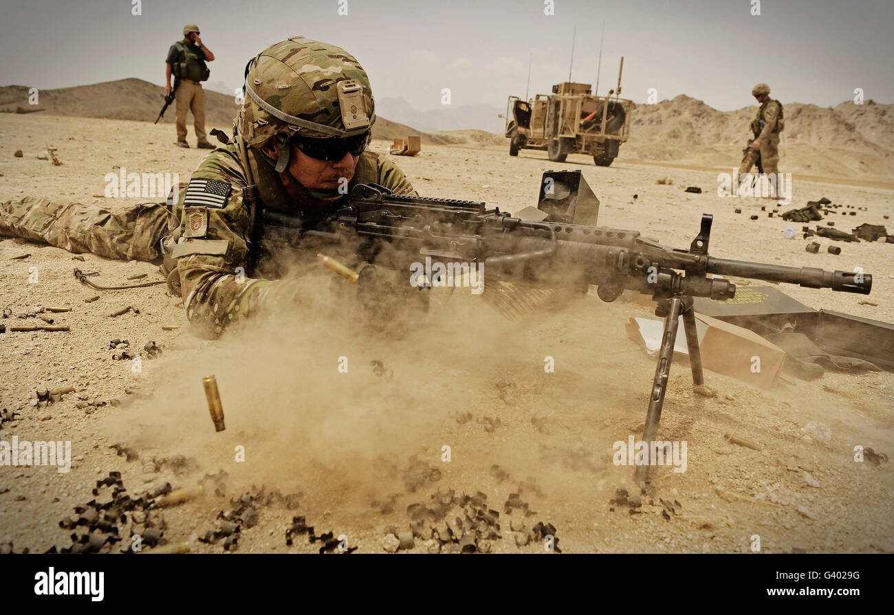 A soldier firing his MK-48 machine gun. Stock Photo
