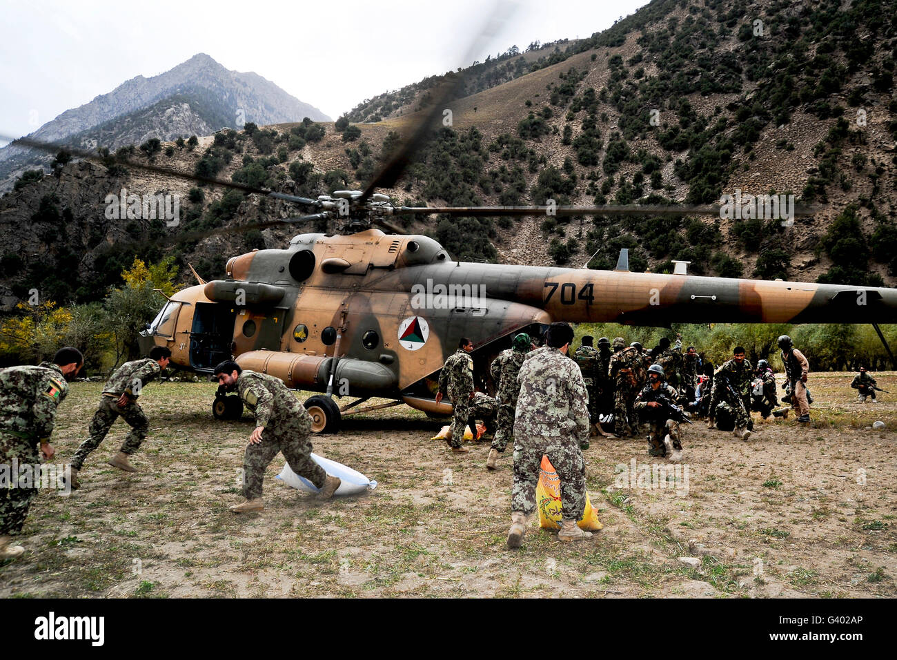 Afghan National Army soldiers unload supplies from an Afghan Air Force Mi-17 helicopter. Stock Photo