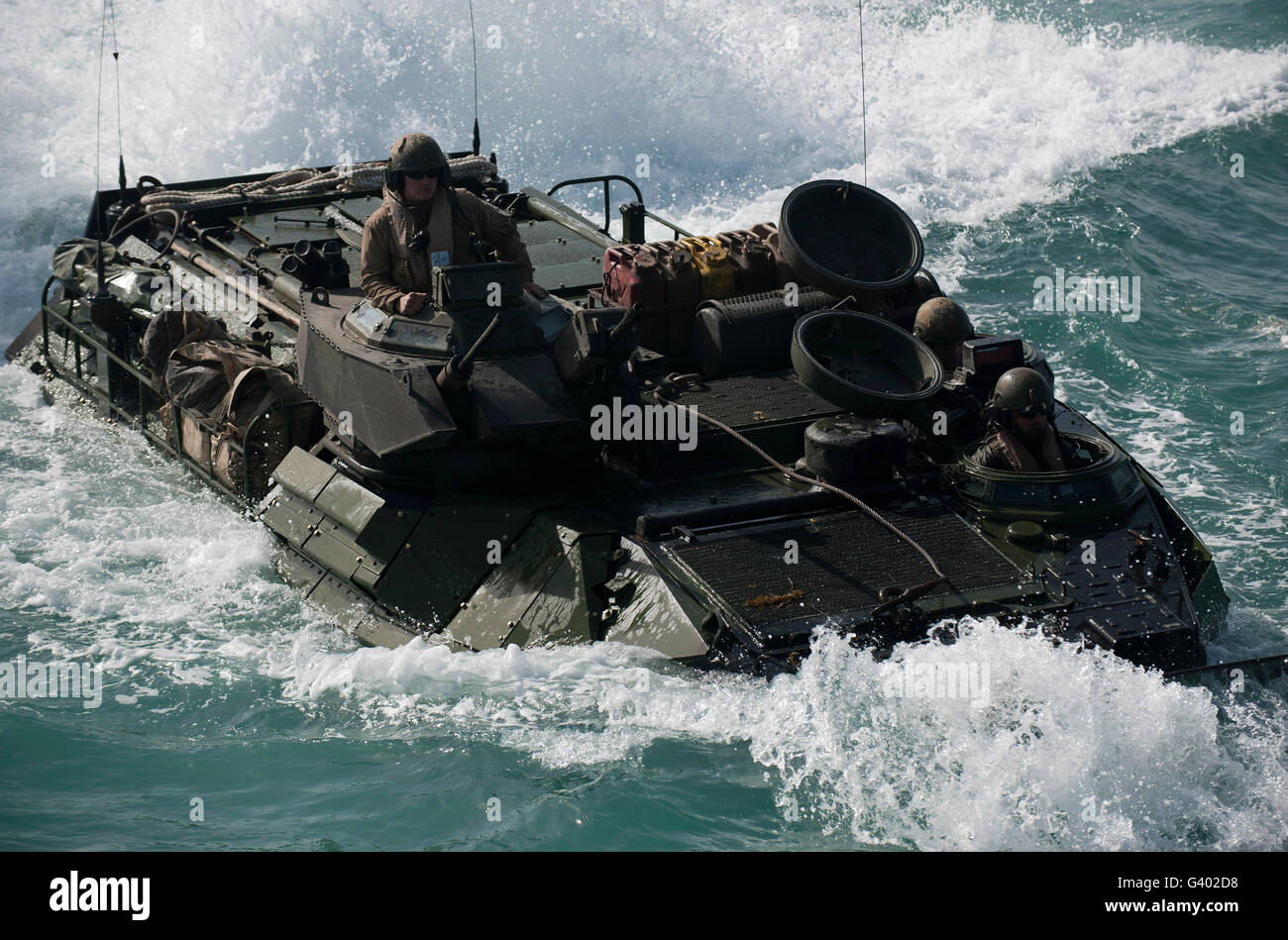 Marines drive an amphibious assault vehicle into the well deck of USS New Orleans. Stock Photo