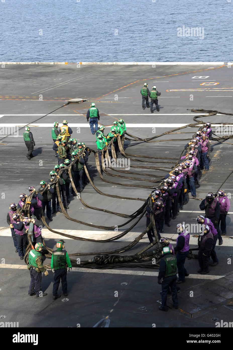 Sailors participate in a barricade drill on the flight deck of USS George H.W. Bush. Stock Photo