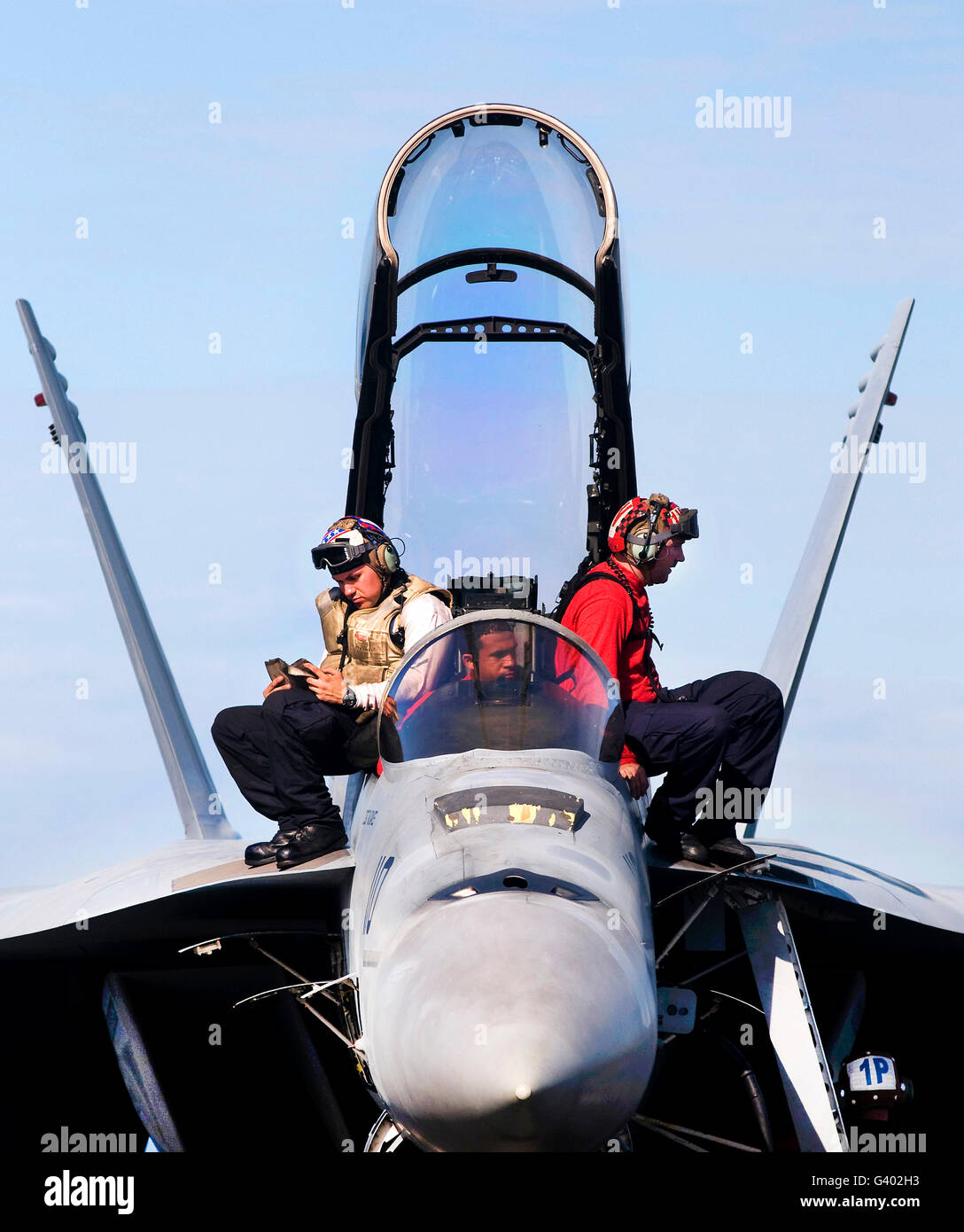 Airmen perform a weapons release check on an F/A-18F Super Hornet. Stock Photo