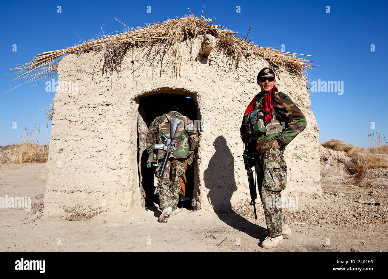 Afghan National Army soldier holds security outside a shop in Afghanistan. Stock Photo