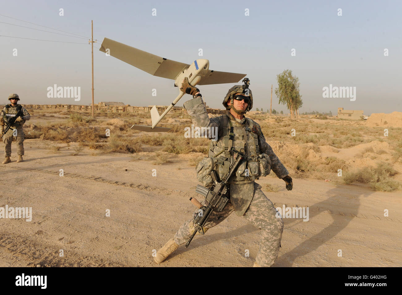 U.S. Army Specialist launches an RQ-11 Raven unmanned aerial vehicle. Stock Photo