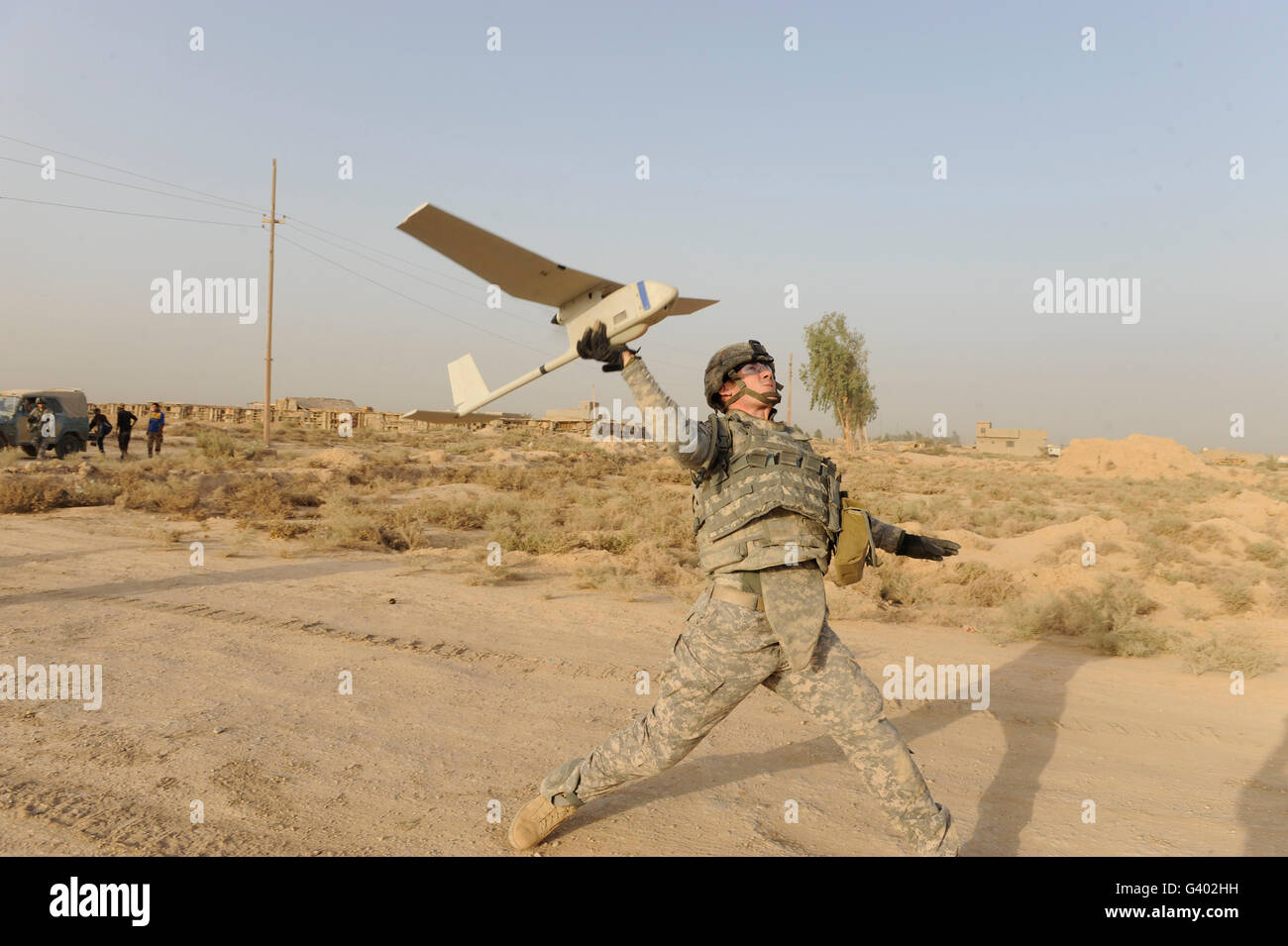 U.S. Army soldier launches an RQ-11 Raven unmanned aerial vehicle. Stock Photo