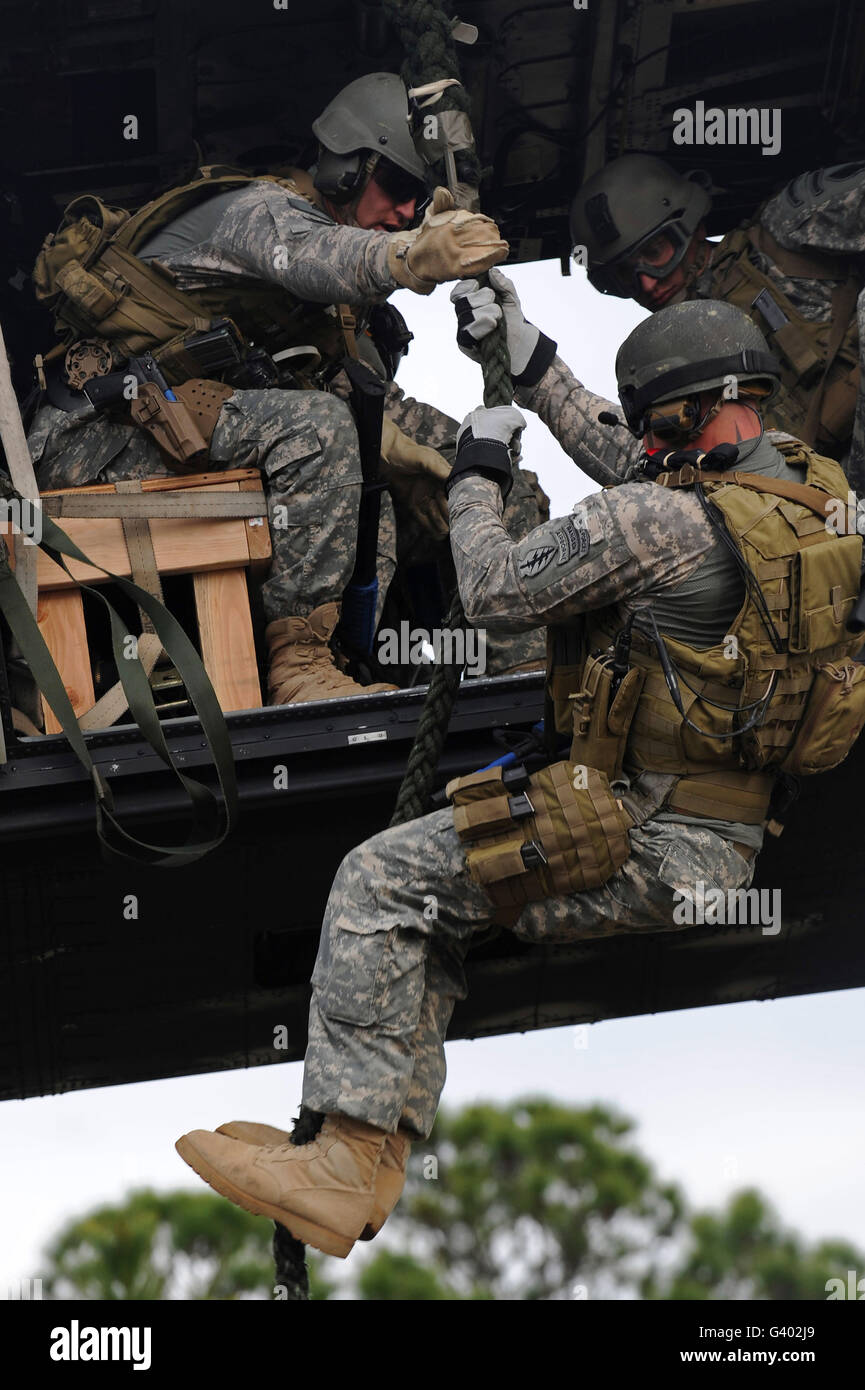 U.S. Special Operations soldiers fast-rope from a helicopter. Stock Photo