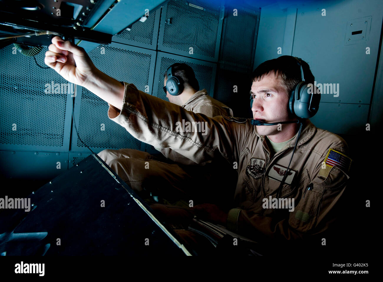 KC-10 Extender boom operator adjusts his mirror before refueling. Stock Photo