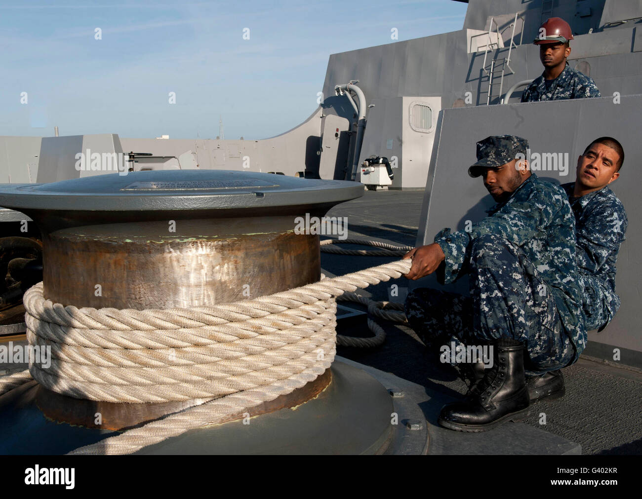 Sailors handle mooring lines aboard USS New York. Stock Photo
